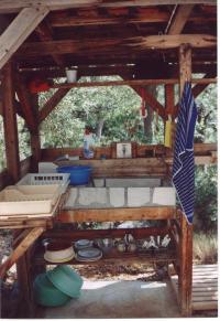  [Picture: The little wooden house with its summer-sink and the shower] 